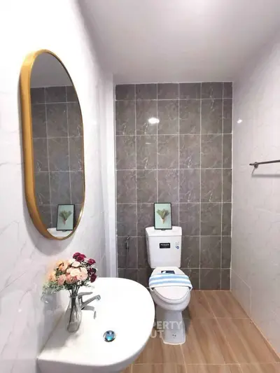 Modern bathroom with elegant oval mirror and stylish decor