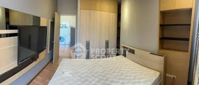 Spacious bedroom with modern furnishings and in-room laundry facilities