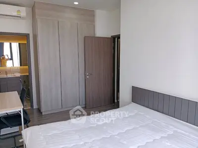 Modern bedroom with sleek wardrobe and cozy bed in stylish apartment.