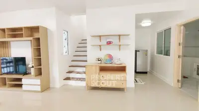 Modern living room with wooden furniture and staircase in bright minimalist design.