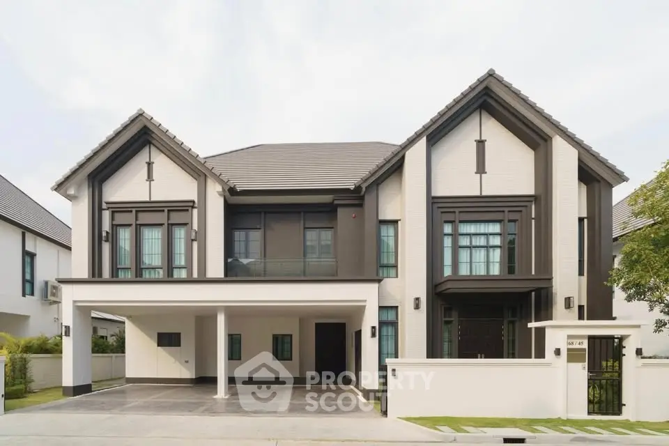 Stunning modern two-story house with elegant facade and spacious driveway in a serene neighborhood.