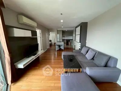 Modern living room with sleek furniture and open layout, featuring a cozy sofa and stylish decor.