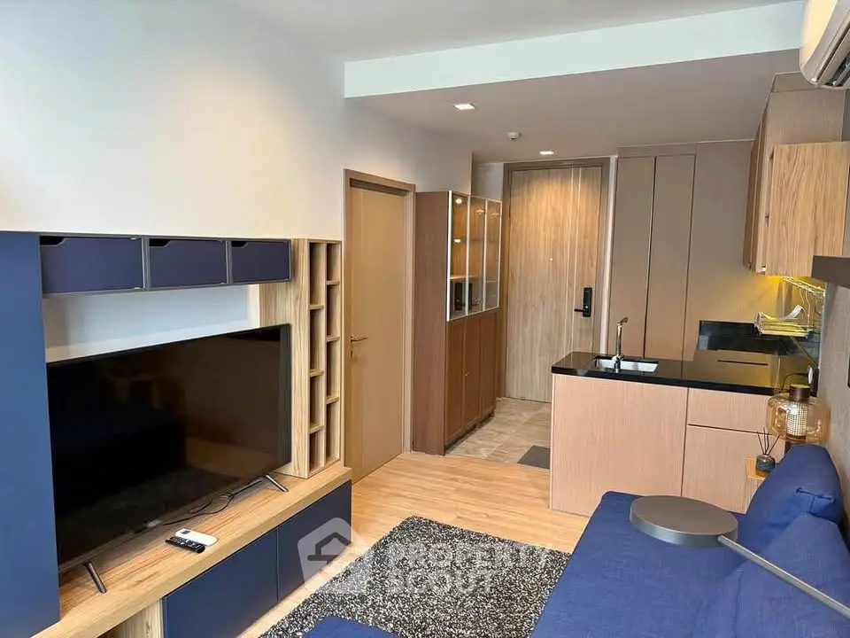 Modern living room with sleek kitchen and stylish decor