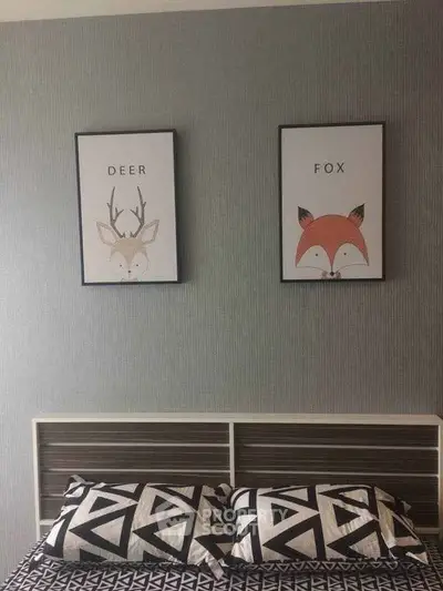 Stylish bedroom with modern decor and animal-themed artwork above bed.