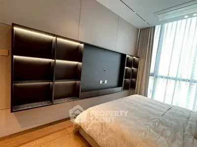 Modern bedroom with sleek built-in shelving and large window