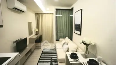 Modern living room with stylish decor and open layout, featuring a cozy sofa and dining area.