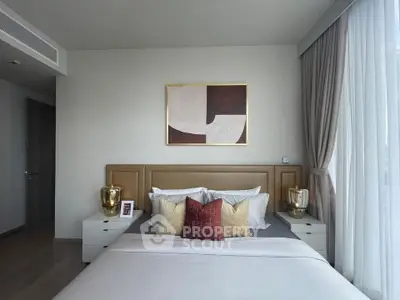 Luxurious bedroom with elegant decor and large window for natural light.