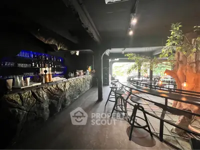 Chic modern bar with unique tree decor and ambient lighting
