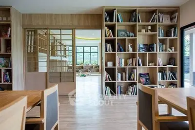 Spacious modern living room with wooden bookshelves and elegant decor