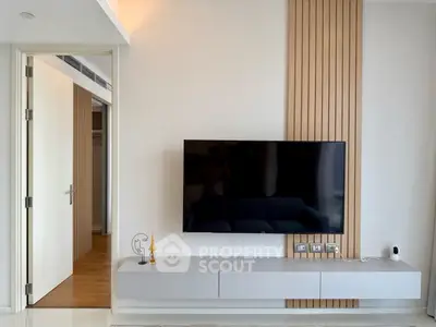 Modern living room with sleek TV setup and stylish wooden paneling