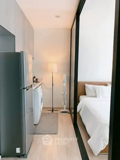 Modern compact apartment with sleek kitchen and cozy bedroom