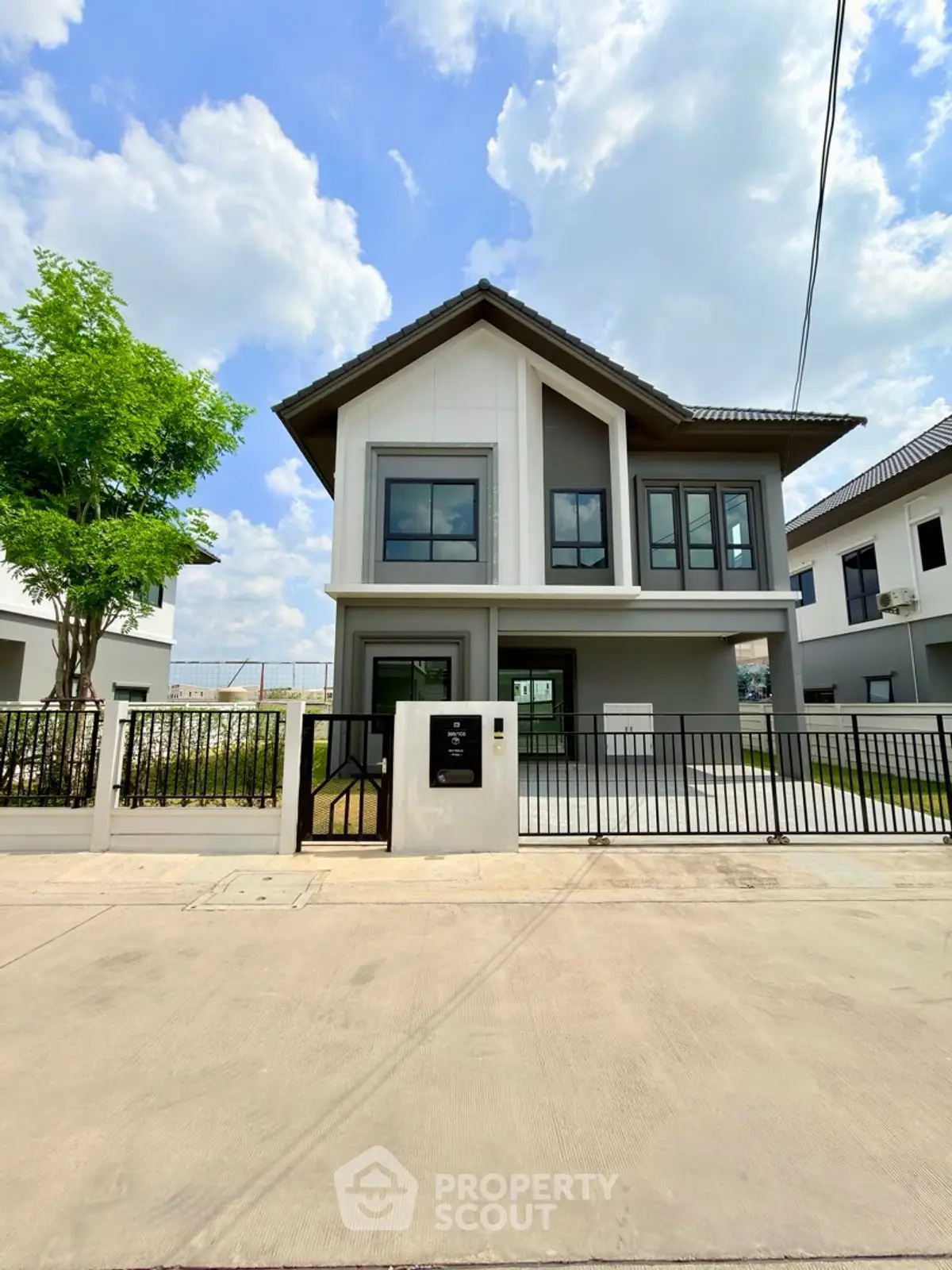 Modern two-story house with sleek design and spacious driveway