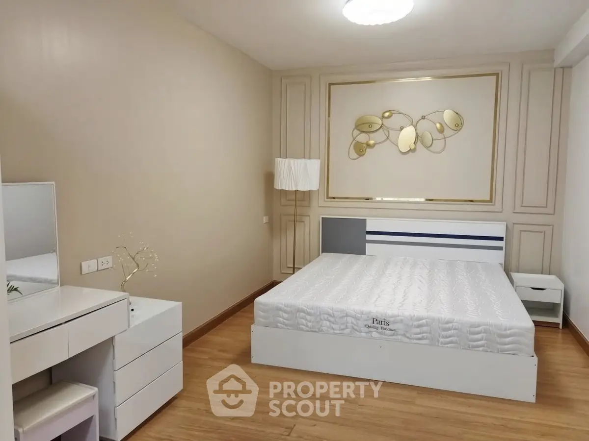 Spacious modern bedroom with elegant decor and wooden flooring
