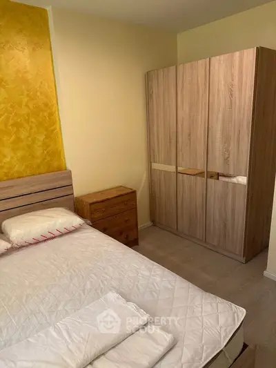 Cozy bedroom with wooden wardrobe and modern decor