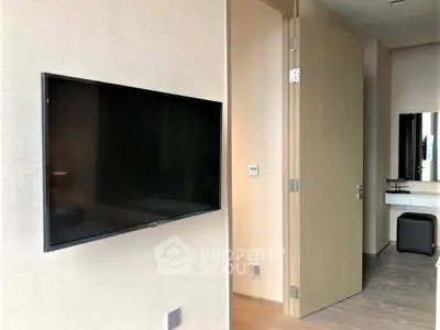 Modern bedroom with wall-mounted TV and sleek decor