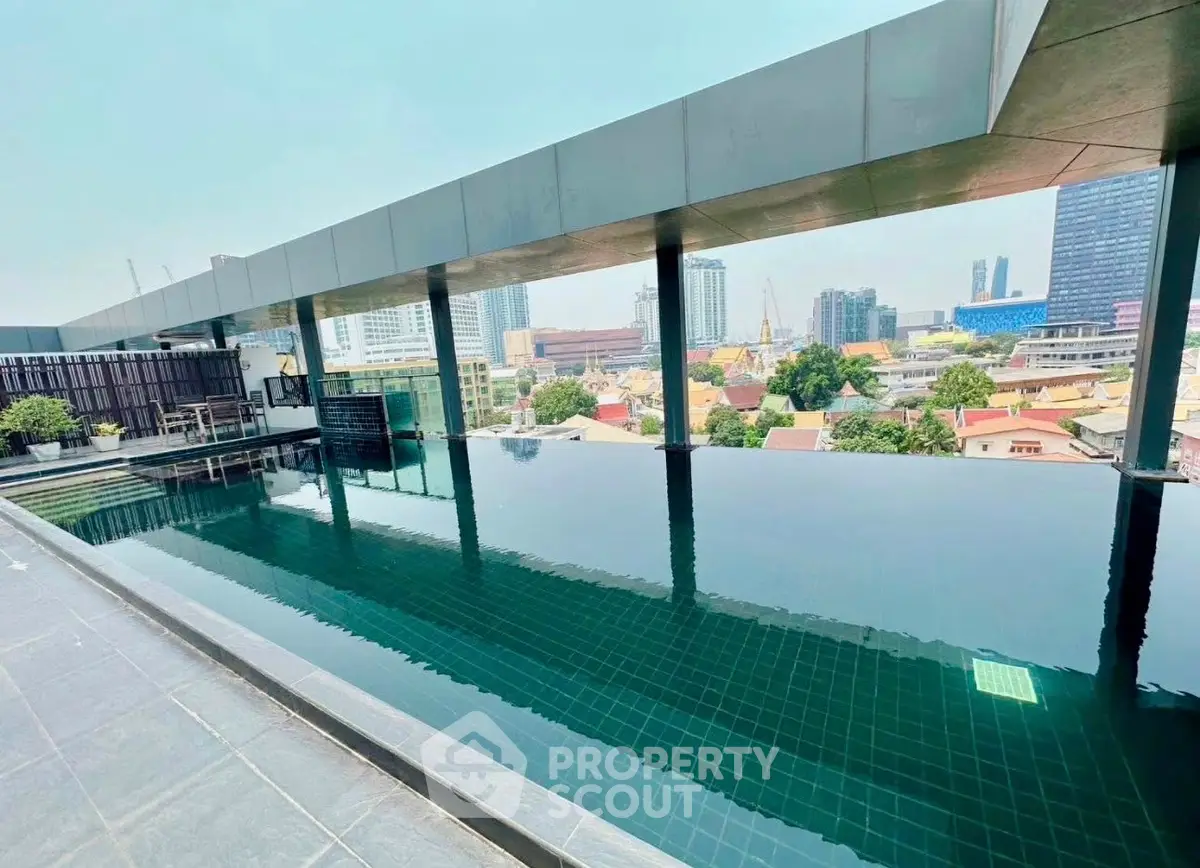 Luxurious rooftop infinity pool with stunning cityscape views, perfect for relaxation and leisure in urban living.