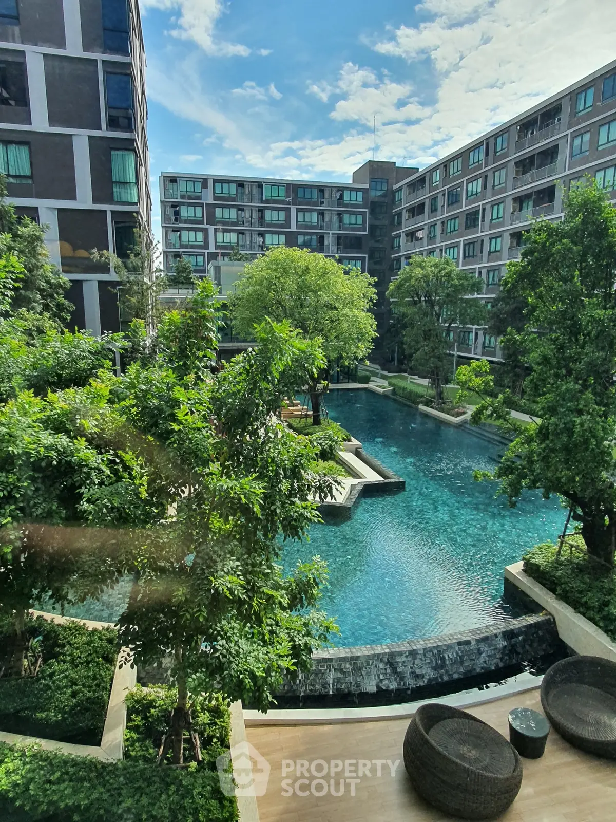 Luxurious residential complex with stunning pool and lush greenery