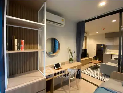 Modern studio apartment with open layout, featuring a cozy living area and stylish kitchen.