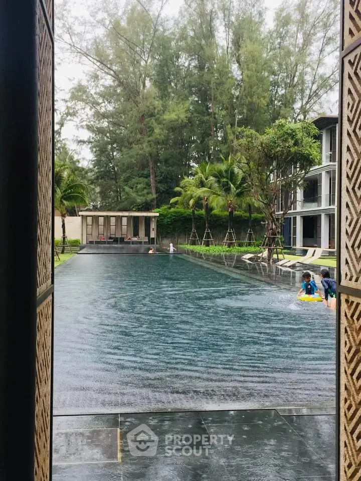 Luxurious outdoor pool area with lush greenery and modern architecture, perfect for relaxation and leisure.