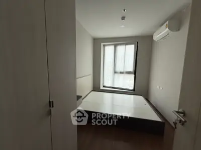 Modern minimalist bedroom with platform bed and air conditioning