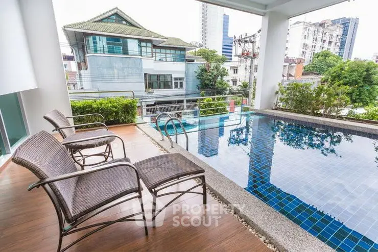 Luxurious poolside view with modern architecture and lush greenery