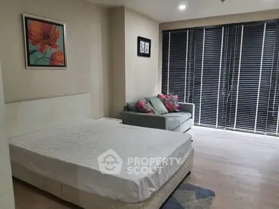 Spacious bedroom with modern decor and natural light