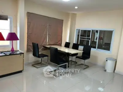 Modern dining area with sleek table and chairs, perfect for family gatherings.