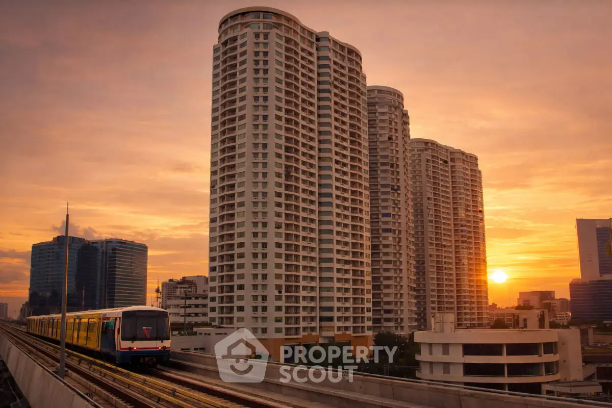 Stunning urban skyline with modern high-rise buildings at sunset, featuring a train passing by.