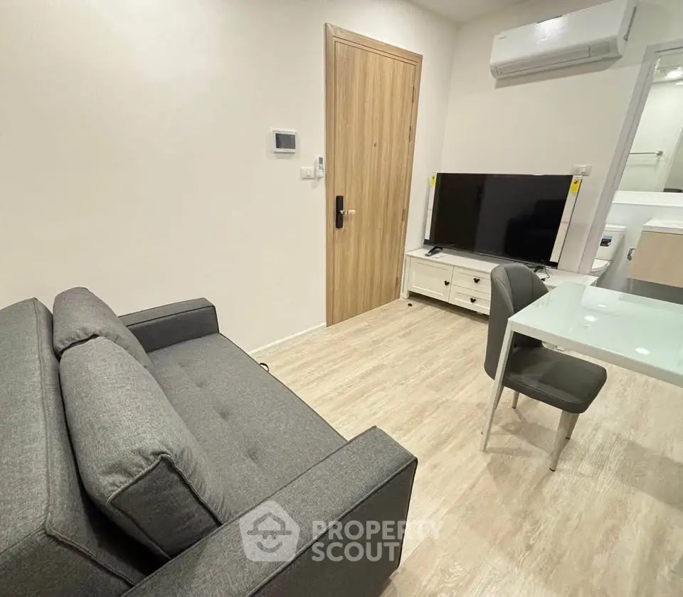 Modern living room with sleek furniture and air conditioning in a cozy apartment.