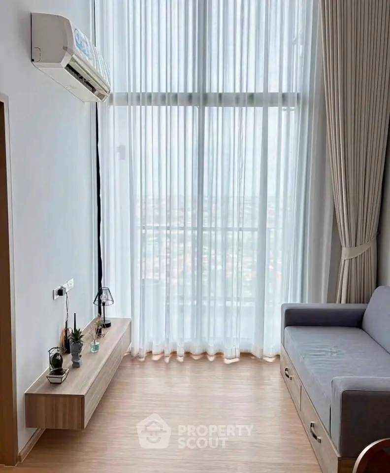 Modern living room with high ceilings and large windows offering a stunning view.