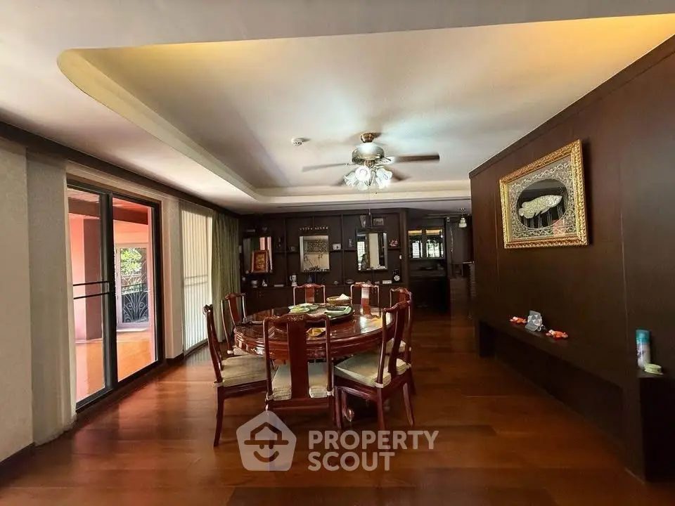Elegant dining room with wooden floors and large windows in luxury home