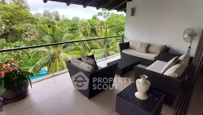 Luxurious balcony with stunning tropical garden view and elegant outdoor seating