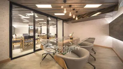 Modern office space with glass table and stylish lighting, perfect for meetings and collaboration.