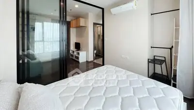 Modern bedroom with glass partition and air conditioning in stylish apartment.