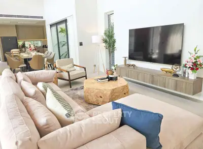 Spacious modern living room with elegant decor and open kitchen layout.