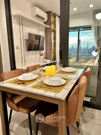 Modern dining area with elegant table setting and city view from balcony.