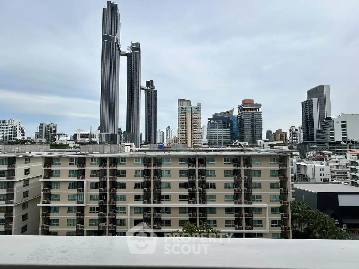 Stunning cityscape view from a high-rise balcony showcasing modern skyscrapers and urban skyline.