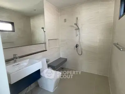 Modern minimalist bathroom with sleek fixtures and neutral tiles