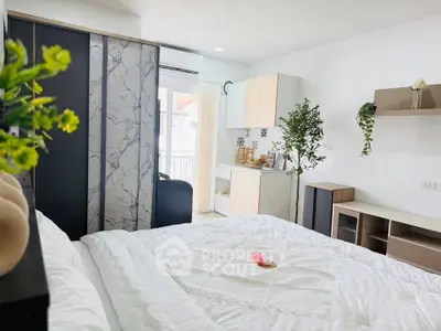 Modern bedroom with stylish decor and natural light, featuring a cozy bed and elegant furnishings.