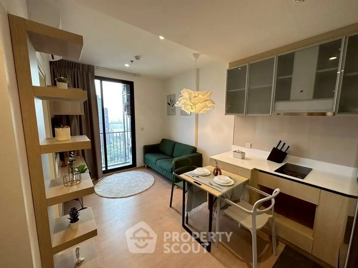 Modern living room with open kitchen and balcony view, stylish decor and cozy ambiance.
