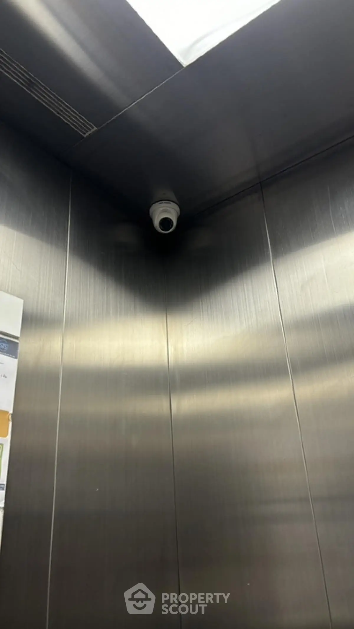 Modern elevator interior with security camera in sleek building