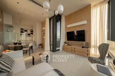 Modern living room with elegant decor and large windows offering natural light.