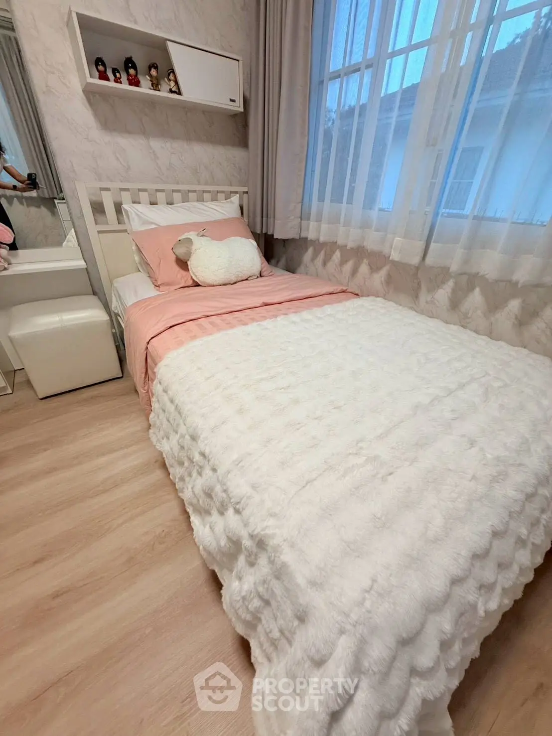 Cozy bedroom with plush bedding and soft lighting, perfect for relaxation and comfort.