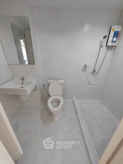 Modern bathroom with sleek white tiles and shower area