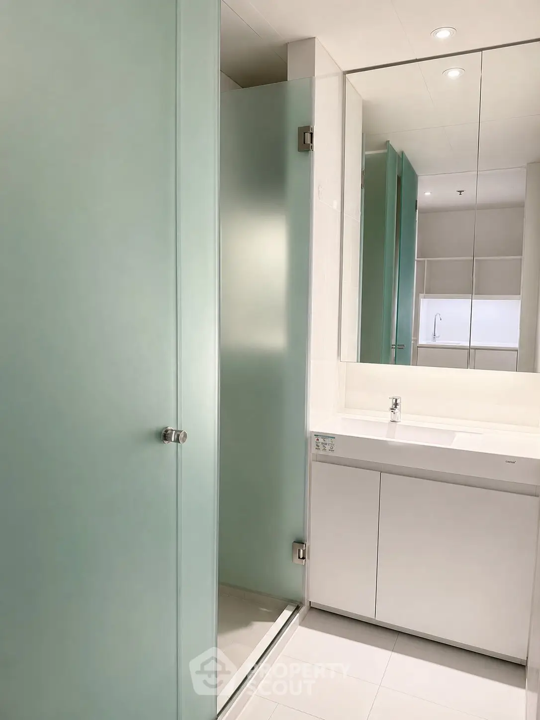 Modern bathroom with sleek frosted glass shower and minimalist vanity