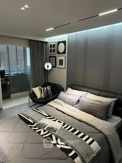 Modern bedroom with stylish decor and open kitchen view