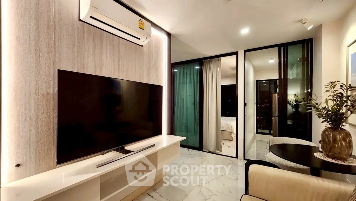 Modern living room with sleek TV setup and air conditioning, featuring elegant marble flooring.