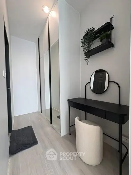 Modern minimalist study area with sleek black desk and round mirror