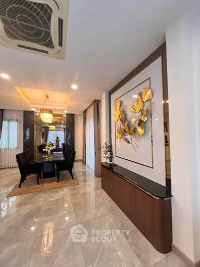 Luxurious dining area with elegant decor and modern lighting in a spacious open layout.