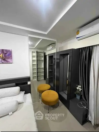 Modern bedroom with sleek furniture and stylish decor, featuring a cozy bed and elegant storage solutions.